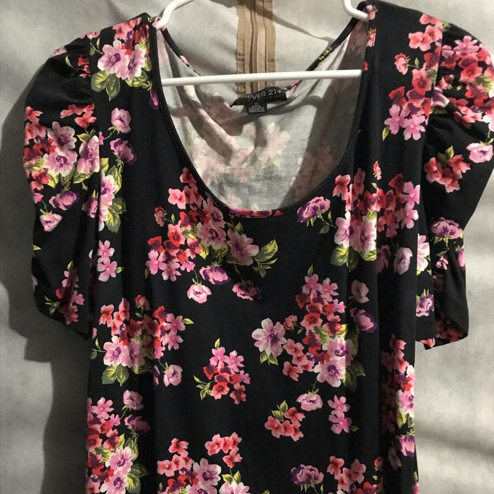 Black floral blouse with scrunched arms.